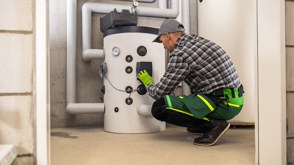 HVAC technician replacing a hot water tank in an Schenectady, NY home