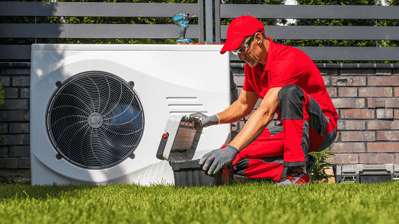 Licensed HVAC professional servicing a residential furnace in Schenectady, NY